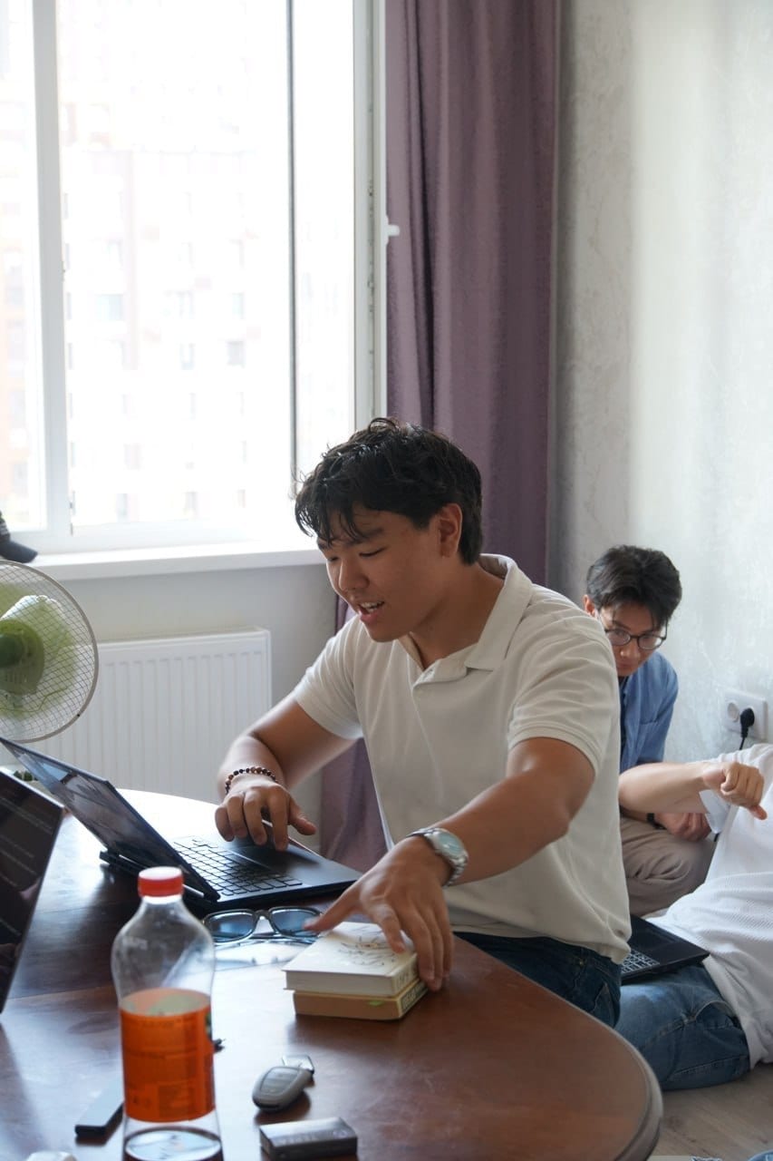 Alim Dauletbek working at his laptop